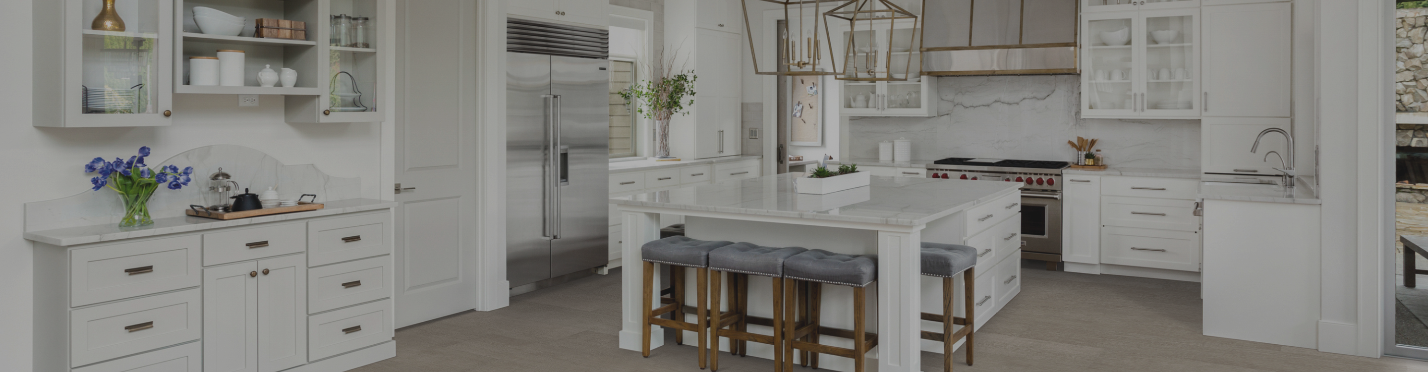 wood-look flooring in a kitchen with white cabinetry and countertops