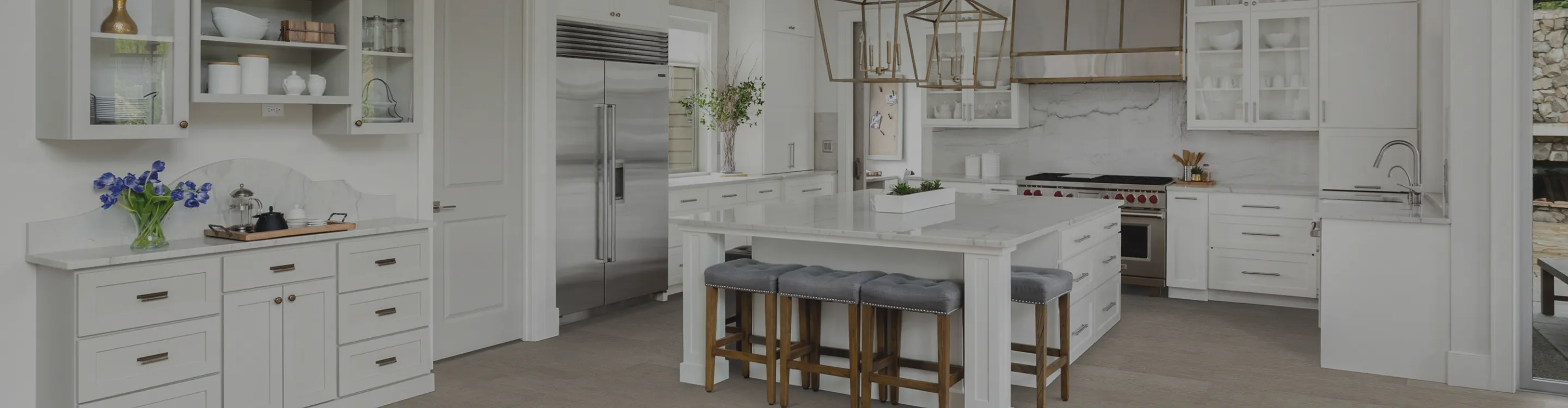 wood-look flooring in a kitchen with white cabinetry and countertops
